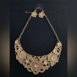 Gold flower pattern statement necklace.